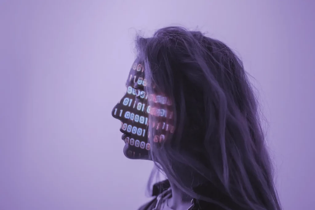 Image of woman with binary code projected onto her face.
