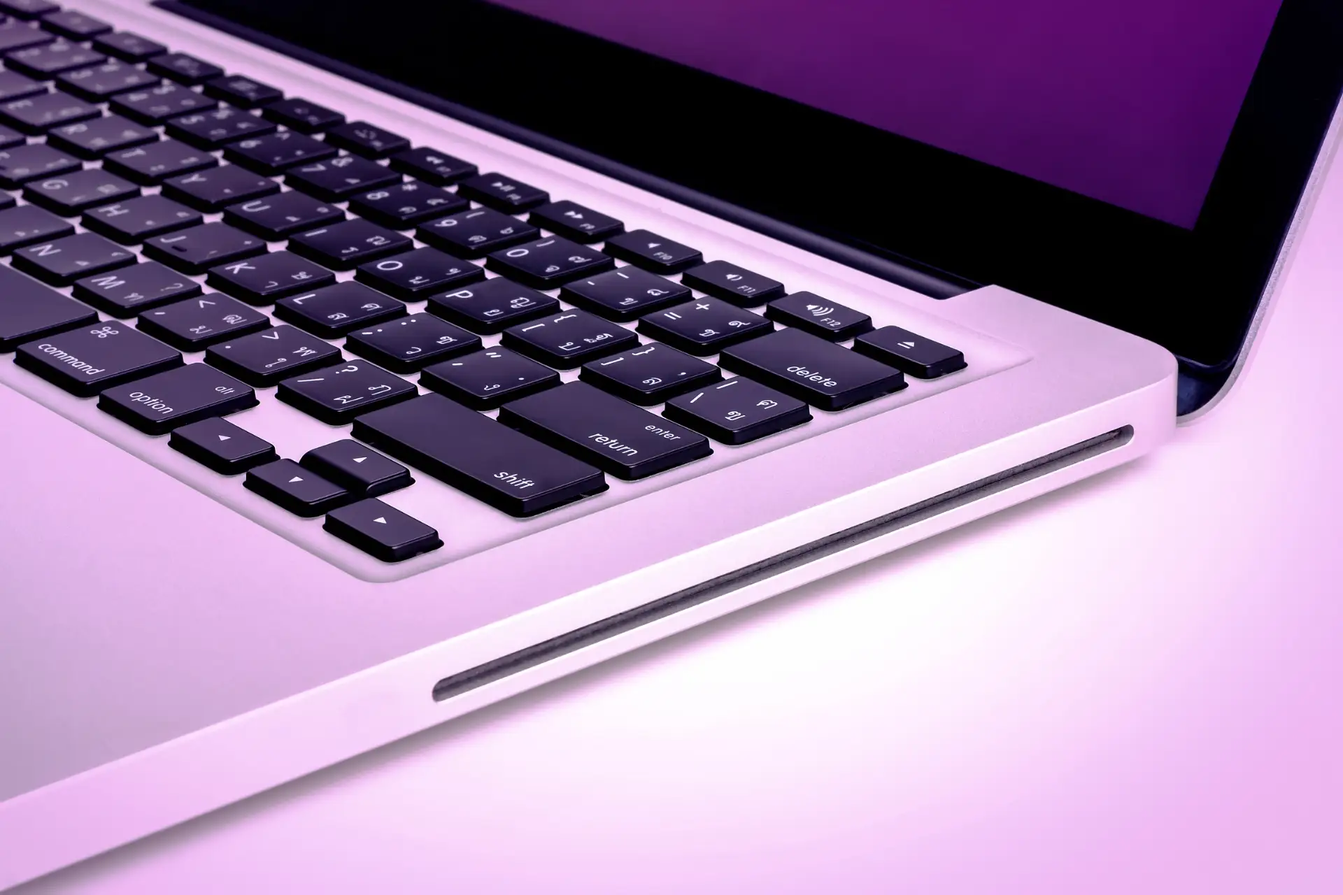 laptop on white with purple filter over image